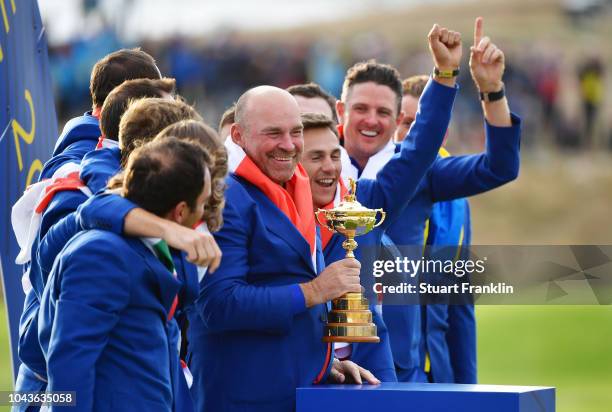 Captain Thomas Bjorn of Europe holds The Ryder Cup as Europe celebrate victory following the singles matches of the 2018 Ryder Cup at Le Golf...