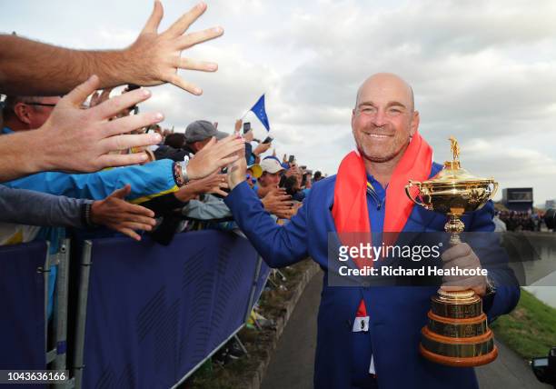 Captain Thomas Bjorn of Europe holds The Ryder Cup as Europe celebrate victory following the singles matches of the 2018 Ryder Cup at Le Golf...