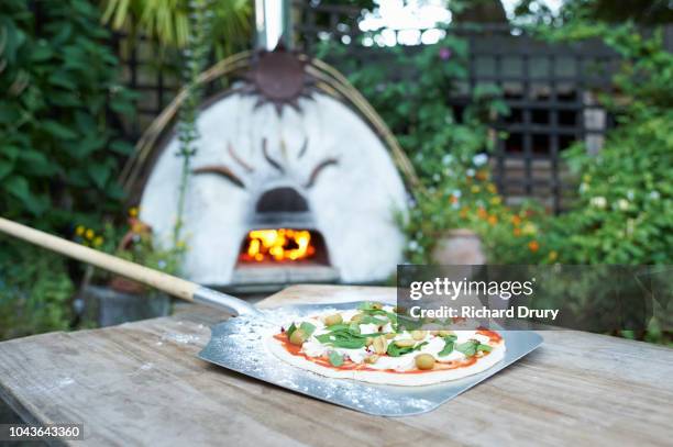 homemade pizza on a pizza peel - pizzaugn bildbanksfoton och bilder