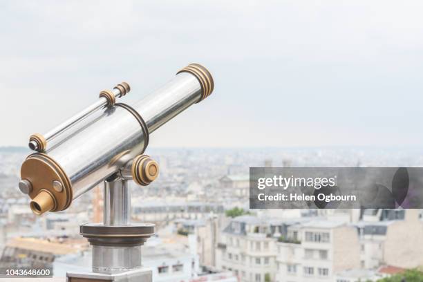 telescope at montmartre looking across paris city buildings - coin operated binocular nobody stock pictures, royalty-free photos & images