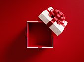 Open White Gift Box Tied With Red Ribbon