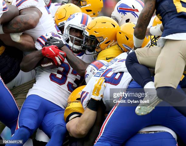 Chris Ivory of the Buffalo Bills is brought down by members of the Green Bay Packers defense during the first quarter of a game at Lambeau Field on...