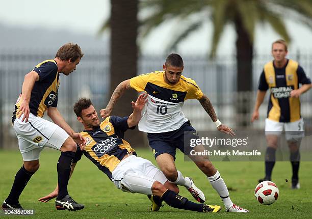 Kerem Bulut of the Young Socceroos is tackled during the friendly match between the Young Socceroos and the Central Coast Mariners at Bluetongue...