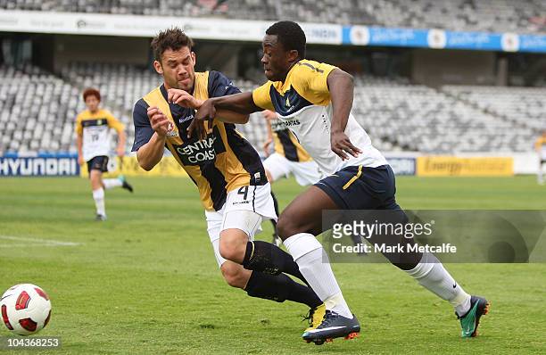 Kofi Danning of the Young Socceroos is challenged by Pedj Bodic of the Mariners during the friendly match between the Young Socceroos and the Central...
