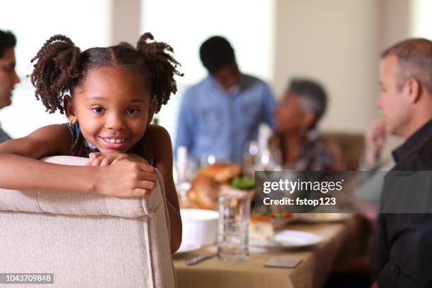 diverse family at dining table eating thanksgiving dinner. - espírito natalino imagens e fotografias de stock