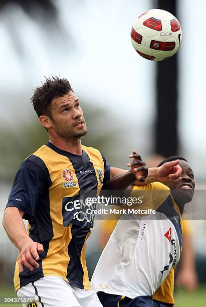 Kofi Danning of the Young Socceroos is challenged by Pedj Bodic of the Mariners during the friendly match between the Young Socceroos and the Central...