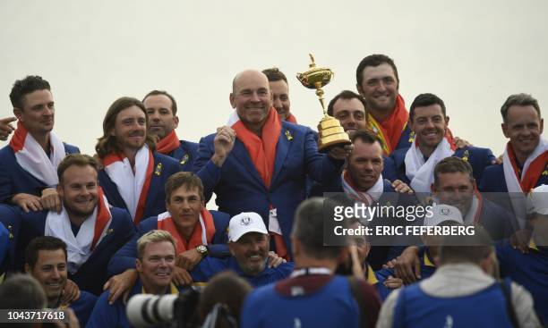 Europe's Danish captain Thomas Bjorn poses with his team after winning the 42nd Ryder Cup at Le Golf National Course at Saint-Quentin-en-Yvelines,...