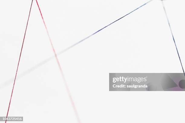 red thread and blue thread against white - white thread stock pictures, royalty-free photos & images