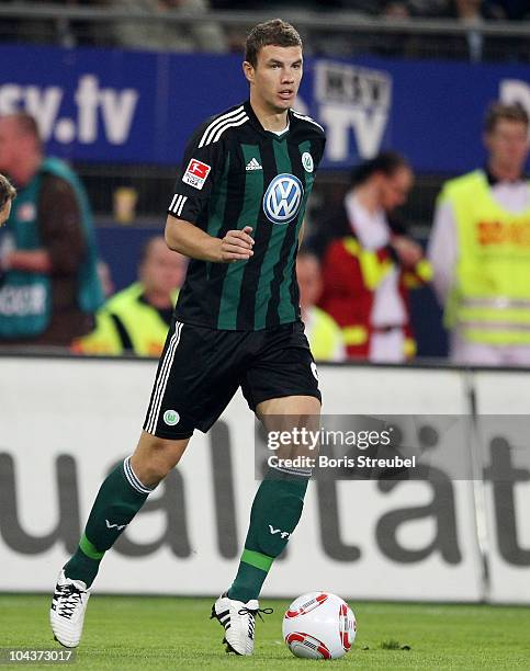 Edin Dzeko of Wolfsburg runs with the ball during the Bundesliga match between Hamburger SV and VFL Wolfsburg at Imtech Arena on September 22, 2010...