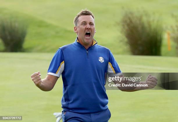 Ian Poulter of England and the European Team celebrates on the 18th green after his win against Dustin Johnson by 2 holes in Europe's 17.5-10.5 win...