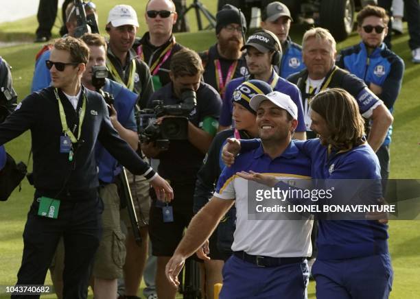 Europe's Italian golfer Francesco Molinari and Europe's English golfer Tommy Fleetwood celebrate after winning the 42nd Ryder Cup at Le Golf National...