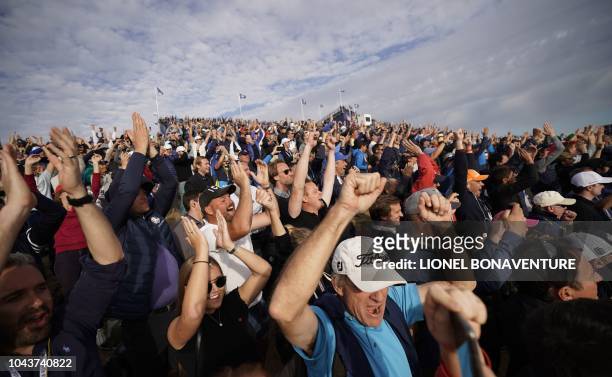 Europe supporters cheer on the third day of the 42nd Ryder Cup at Le Golf National Course at Saint-Quentin-en-Yvelines, south-west of Paris, on...