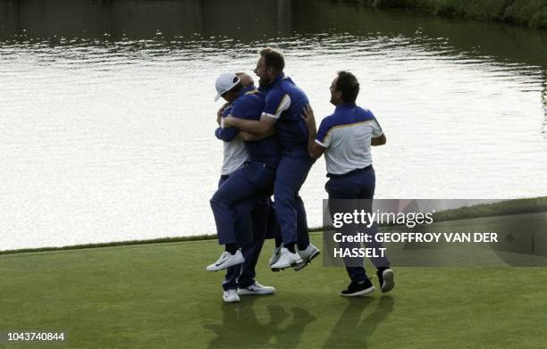 Europe's players celebrate after winning the 42nd Ryder Cup at Le Golf National Course at Saint-Quentin-en-Yvelines, south-west of Paris, on...