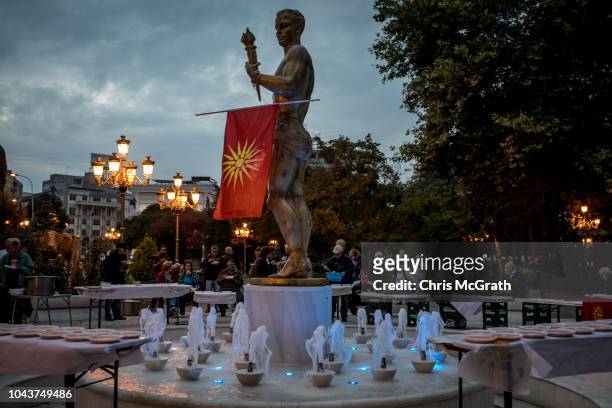 Macedonian national flag hangs from a statue at a gathering of supporters of the movement to boycott the referendum vote on September 30, 2018 in...