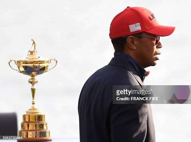 Golfer Tiger Woods walks past the trophy after Europe won the 42nd Ryder Cup at Le Golf National Course at Saint-Quentin-en-Yvelines, south-west of...