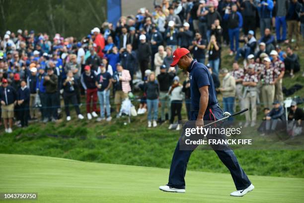 Golfer Tiger Woods walks during his singles match with Europe's Spanish golfer Jon Rahm on the third day of the 42nd Ryder Cup at Le Golf National...