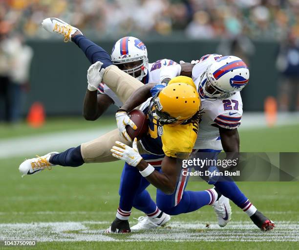 Davante Adams of the Green Bay Packers is tackled by Tre'Davious White of the Buffalo Bills during the second quarter of a game at Lambeau Field on...