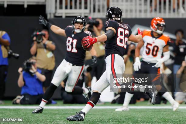 Logan Paulsen of the Atlanta Falcons celebrates a touchdown during the second quarter against the Cincinnati Bengals at Mercedes-Benz Stadium on...