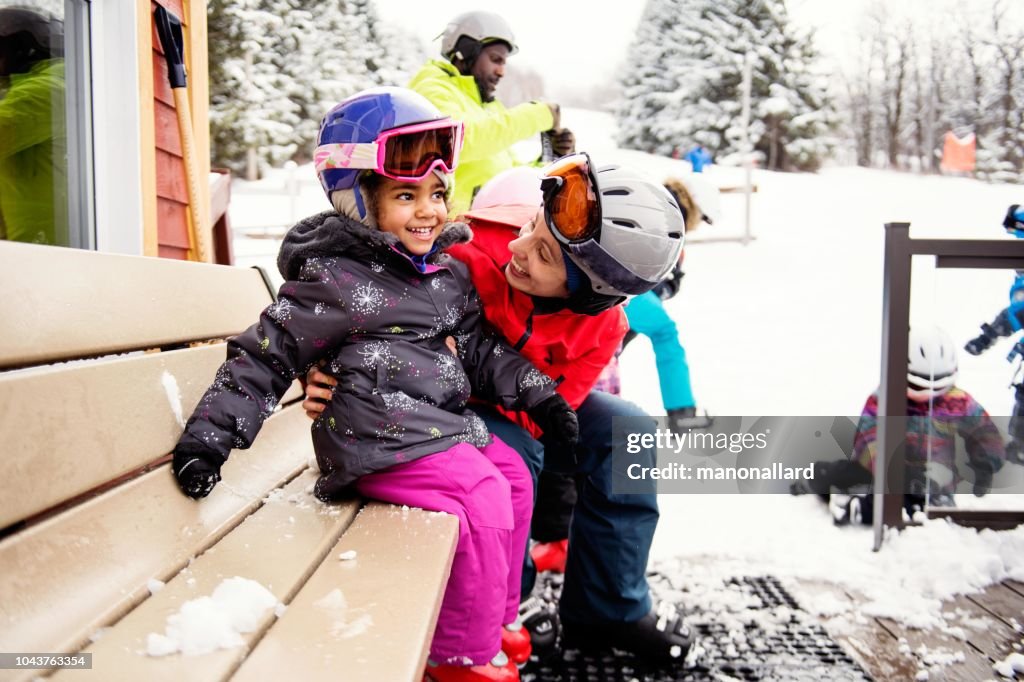 Multi-ethnic family with their friends skying