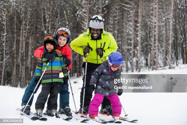 multi-ethnic family with their friends skying - family skiing stock pictures, royalty-free photos & images