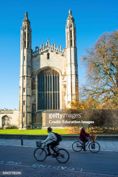 Cyclists go past Kings College Chapel on Kings Parade, Cambridge University, Cambridgeshire, England, UK.