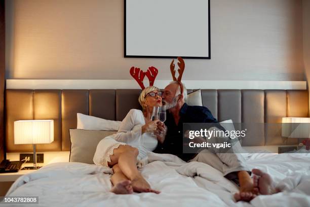senior couple getting ready for new year party - headband stock pictures, royalty-free photos & images