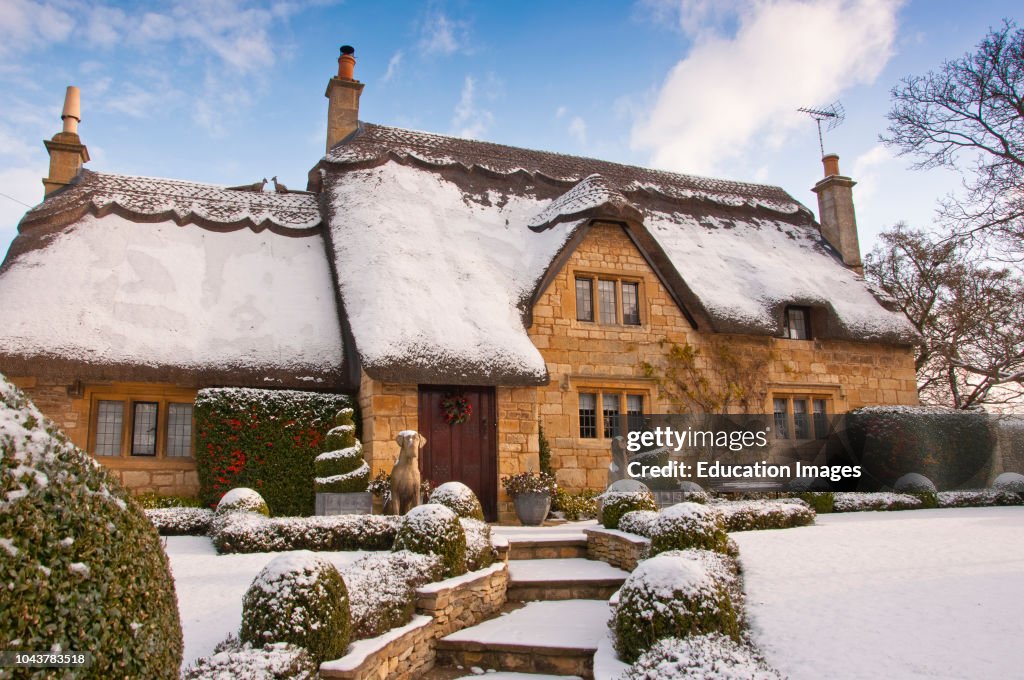 A thatched cottage covered in snow on the edge of the Cotswold village of Chipping Campden England