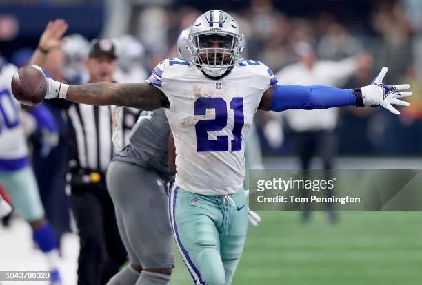 Ezekiel Elliott of the Dallas Cowboys reacts after completing a pass against Jarrad Davis of the Detroit Lions in the fourth quarter at AT&T Stadium...