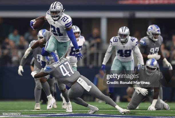 Ezekiel Elliott of the Dallas Cowboys jumps over the tackle by Tracy Walker of the Detroit Lions in the fourth quarter at AT&T Stadium on September...