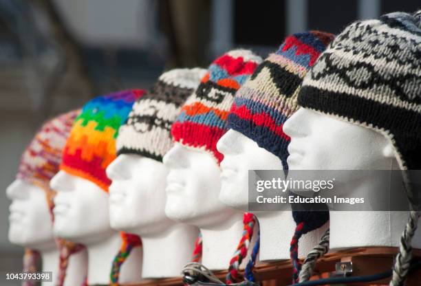 Colorful woolly hats for sale in Worcesters high street on a cold winters day England.