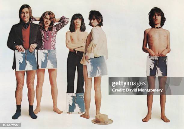 English rock group the Rolling Stones pose, strategically holding copies of their new album 'Sticky Fingers', in a humorous group portrait to promote...