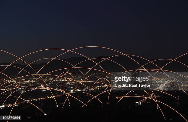 light trails over city - telekommunikationsgerät stock-fotos und bilder