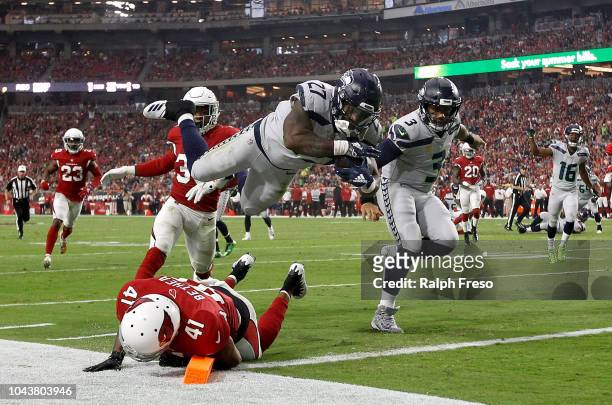Running back Mike Davis of the Seattle Seahawks scores a 20-yard touchdown over defensive back Antoine Bethea of the Arizona Cardinals during the...