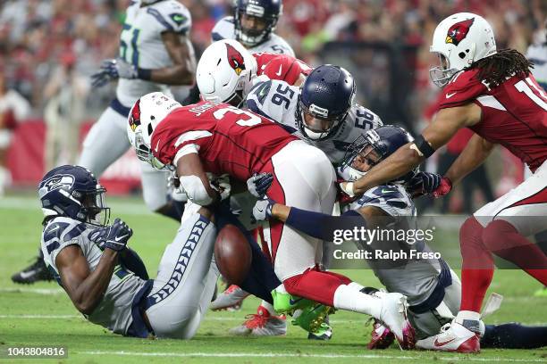 Running back David Johnson of the Arizona Cardinals fumbles after being hit by linebacker Mychal Kendricks, cornerback Tre Flowers and defensive back...
