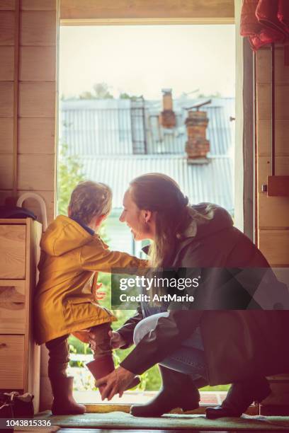 good rainy day for a walk - family getting dressed stock pictures, royalty-free photos & images