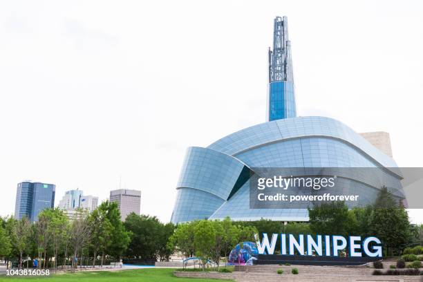 city sign and canadian museum of human rights in winnipeg, manitoba, canada - museum of human rights stock pictures, royalty-free photos & images