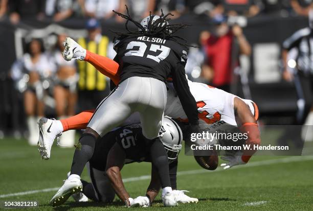 Reggie Nelson and Dominique Rodgers-Cromartie of the Oakland Raiders tackles Carlos Hyde of the Cleveland Browns short of a first down during the...