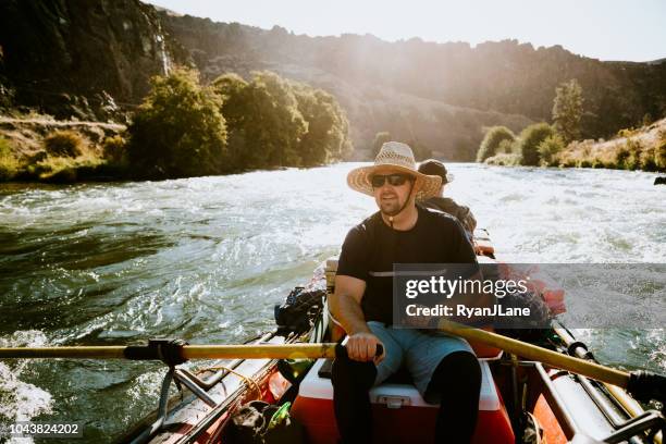 group of friends raft down deschutes river in eastern oregon - white water rafting stock pictures, royalty-free photos & images