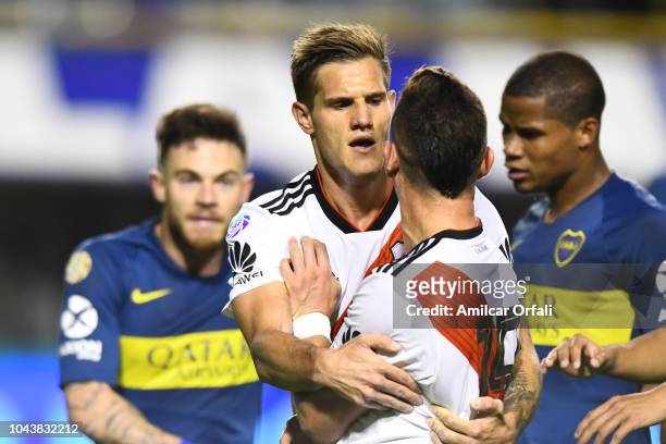 Rafael Santos Borre argues with Nahitan Nandez of Boca Juniors as Bruno Zuculini contains him after the match between Boca Juniors and River Plate as...