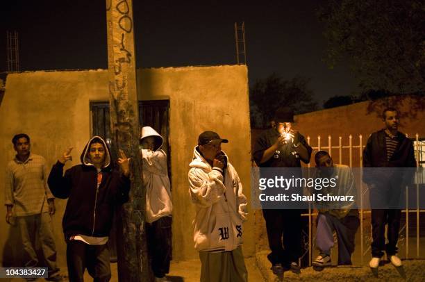 Yound gang members called "Baja 13" hang out in a street corner in the city of Juarez. The violence generated by the war of the drug cartels for...