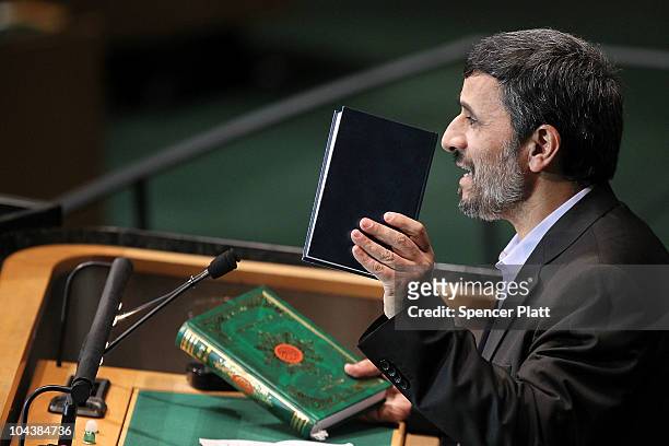 Iranian President Mahmoud Ahmadinejad holds up a Bible and a Koran while addressing world leaders during the General Assembly at the United Nations...