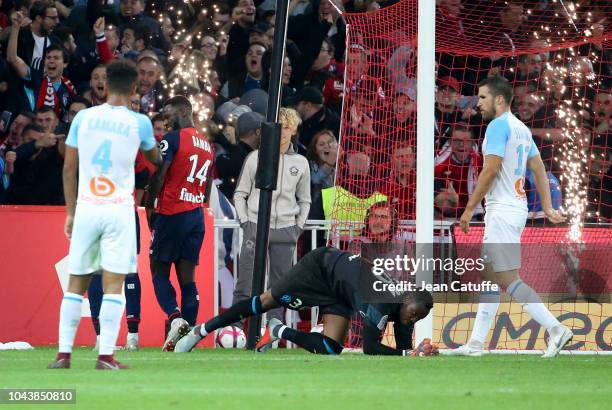 Jonathan Bamba of Lille celebrates his second goal while goalkeeper of Marseille Steve Mandanda lies down during the french Ligue 1 match between...