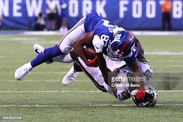 Sterling Shepard of the New York Giants stiff arms Ken Crawley of the New Orleans Saints at MetLife Stadium on September 30, 2018 in East Rutherford,...