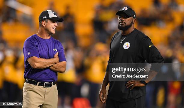 Head coach Mike Tomlin of the Pittsburgh Steelers talks with head coach John Harbaugh of the Baltimore Ravens during warmups before the game at Heinz...