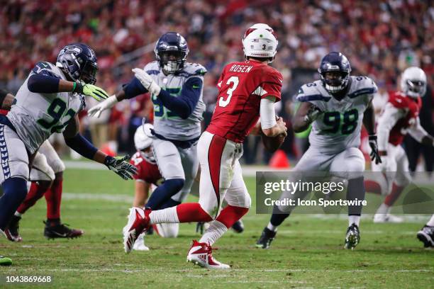 Arizona Cardinals quarterback Josh Rosen scrambles away from Seattle Seahawks defensive tackle Nazair Jones , Seattle Seahawks defensive end Dion...