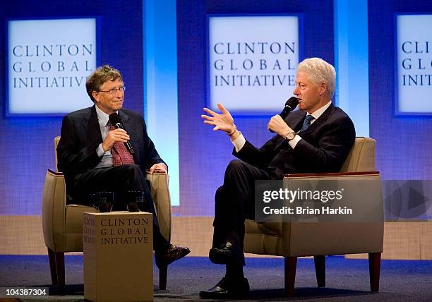 Bill Gates , co-chair and trustee of the Bill and Melinda Gates Foundation, talks with President Bill Clinton during the closing plenary session of...