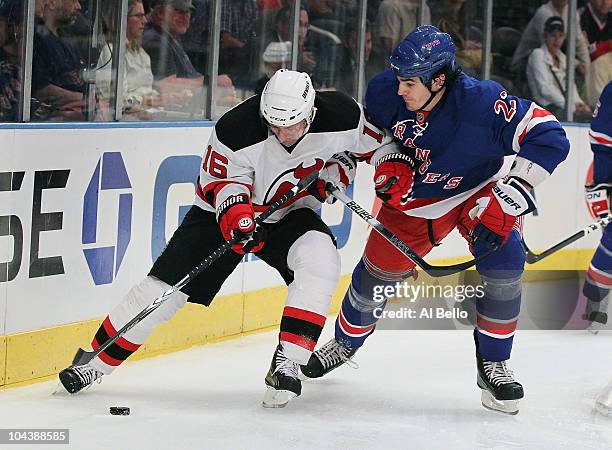 Marcus Nilson of the New Jersey Devils skates with the puck against Brian Bolye of the New York Rangers during their pre season game on September 23,...