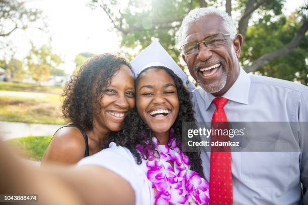 black teenage girl and her family at graduation - highschool party stock pictures, royalty-free photos & images