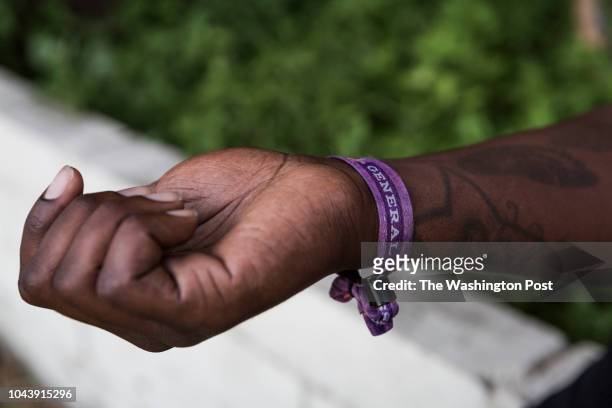Jonathan Smith shows the admission bracelet which he still wears from the 2017 Route 91 Harvest music festival while standing outside his home in...