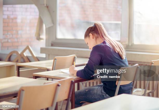 a female college student writes some research notes after school - ssc exam stock pictures, royalty-free photos & images